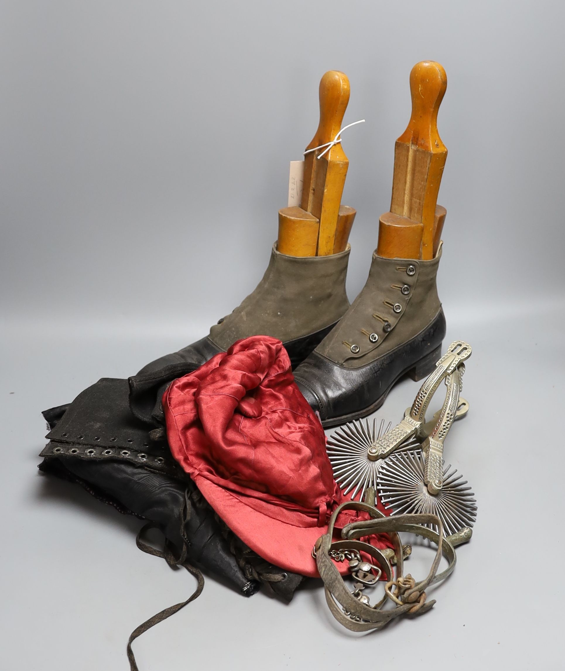 A pair of 19th century buttoned boots, a pair of spats, a red silk jockey's cap, a pair of spurs and another pair sleeves and bodice.